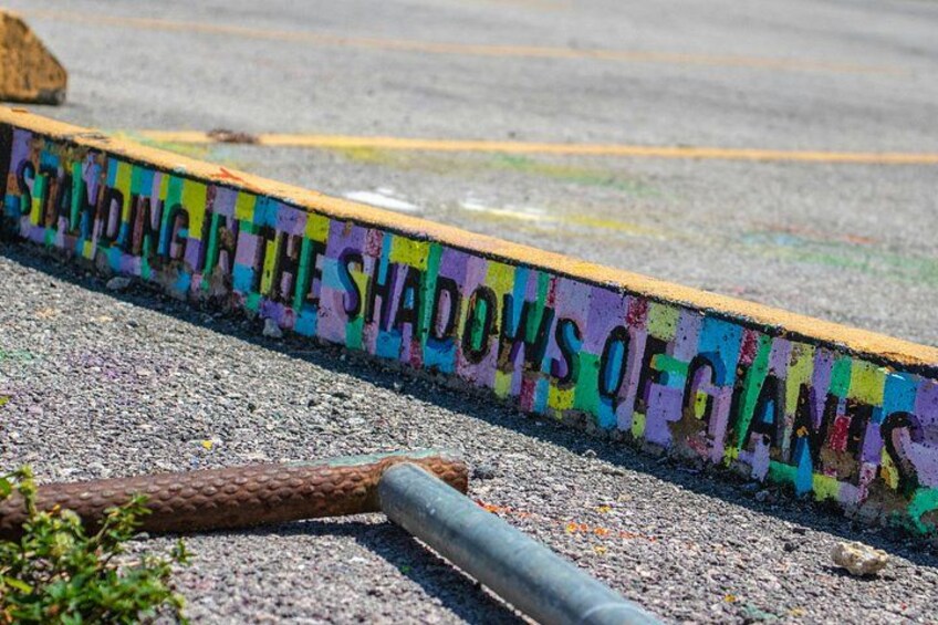 A colorful painted line with text on the ground. 3