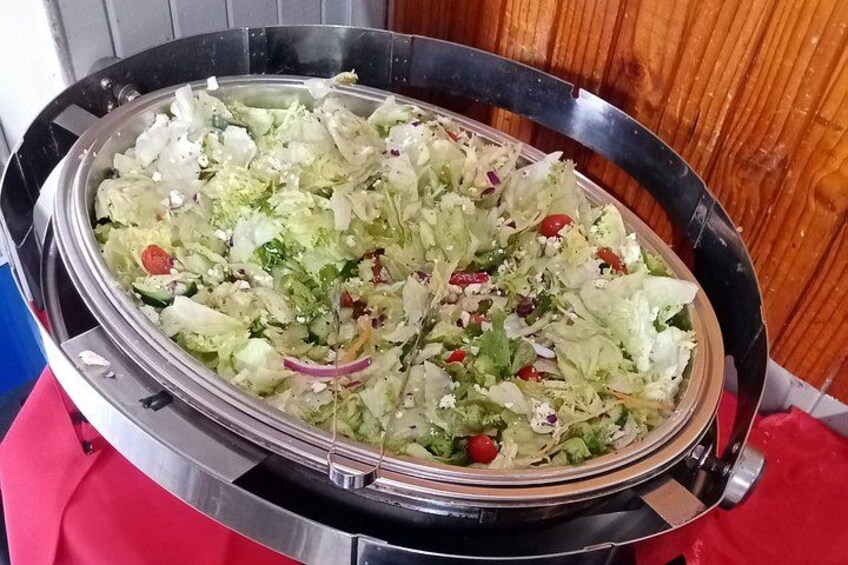 A large salad bowl on a metal stand. 3