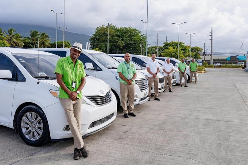 Un grupo de personas frente a coches blancos en un estacionamiento. 2