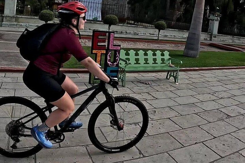 A person riding a bicycle on a paved path. 2