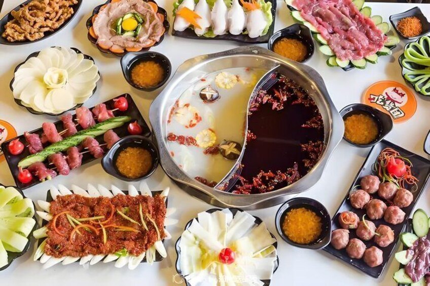 A variety of Asian dishes and a hot pot setup. 3