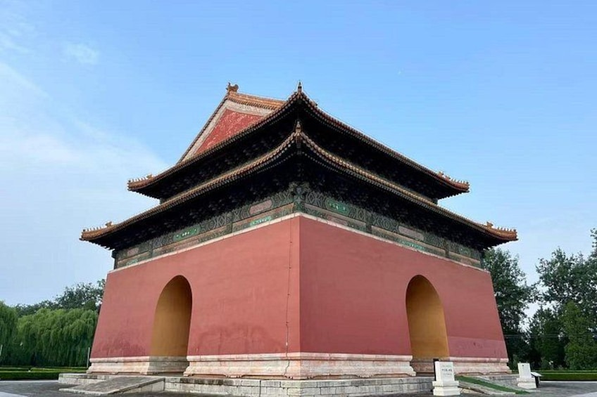 A traditional Chinese building with a red roof and green decorative elements. 4
