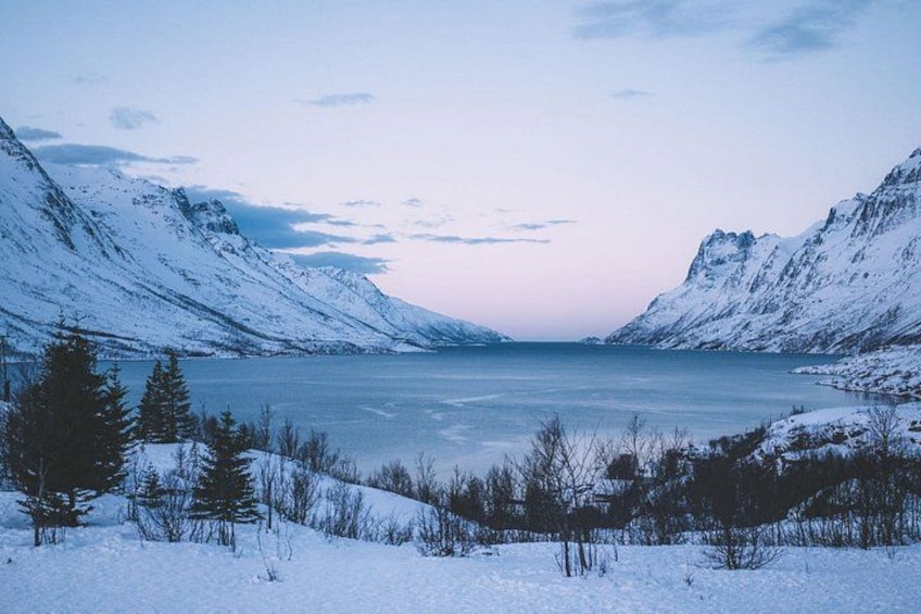 A snow-covered lake surrounded by mountains. 5