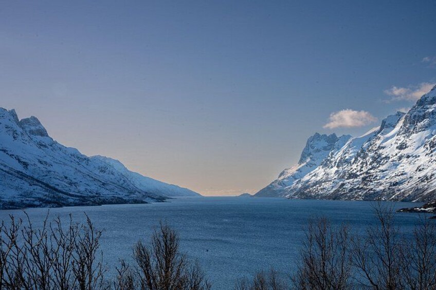 A snow-covered lake with mountains on either side. 2