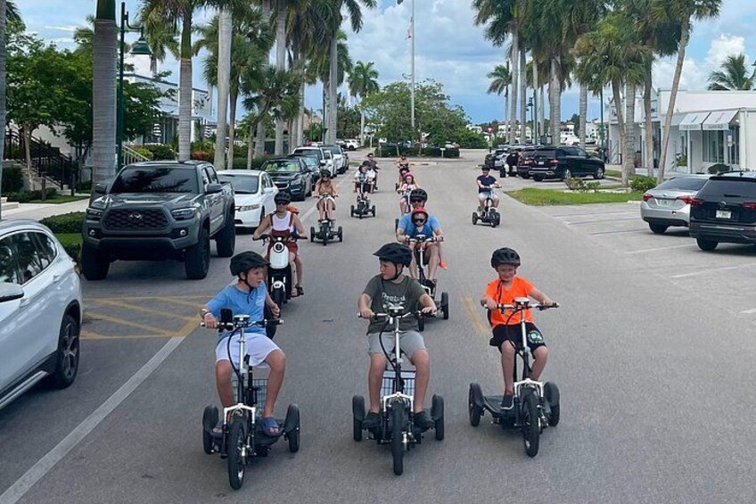 A street with people riding Segways. 4