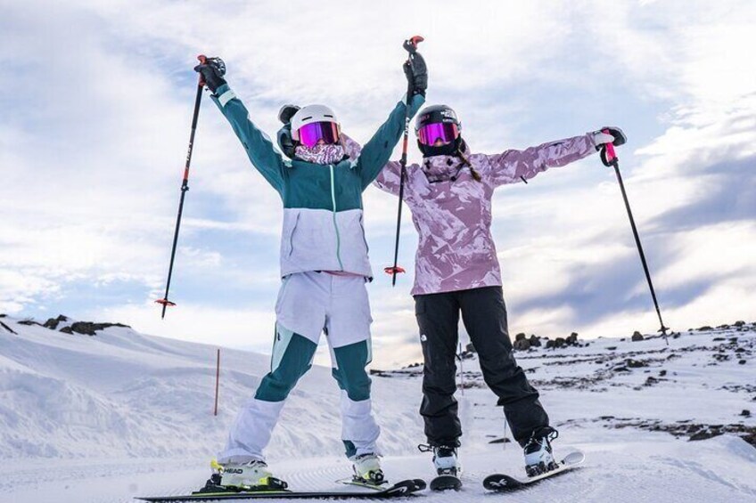 Two people skiing on a snowy slope. 2