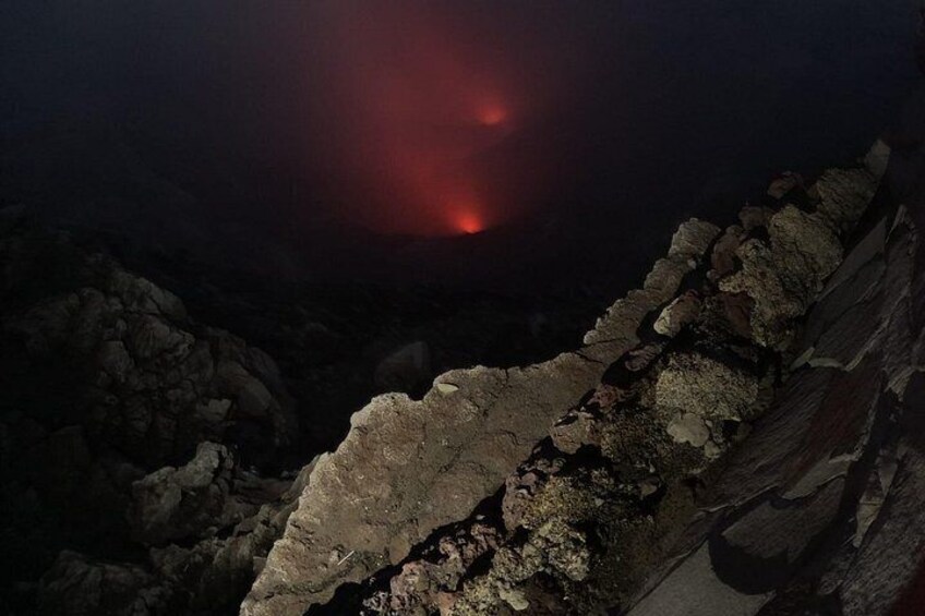 A rocky landscape with a red glow in the distance. 4