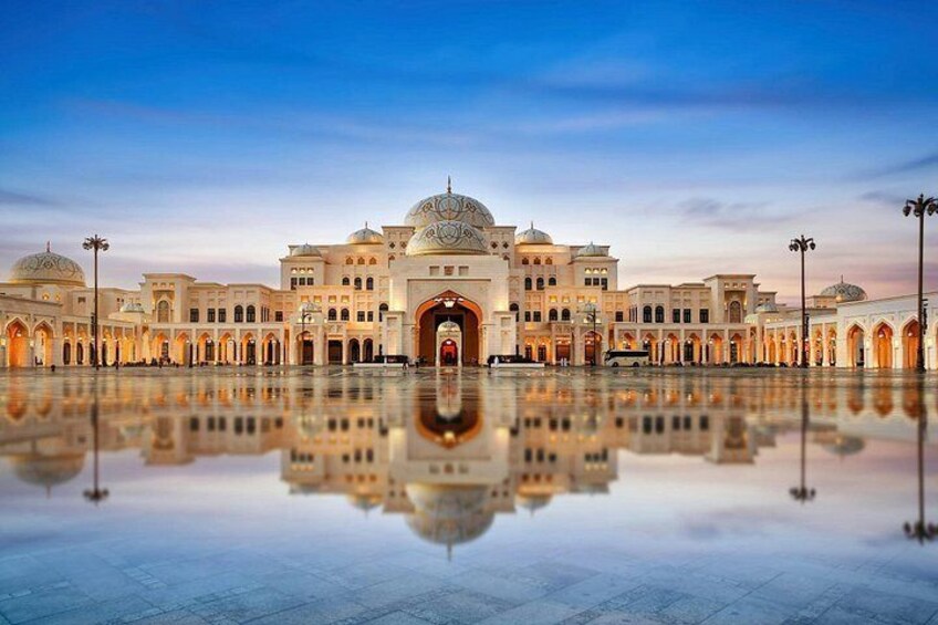 A grand building with domes and arches, reflecting in a still water surface. 5