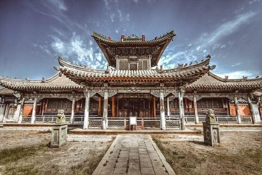 A traditional Chinese building with ornate architecture, a central courtyard, and a clear sky. 5