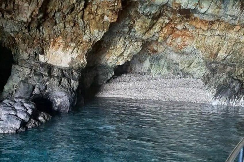 A cave entrance with water flowing into it. 5