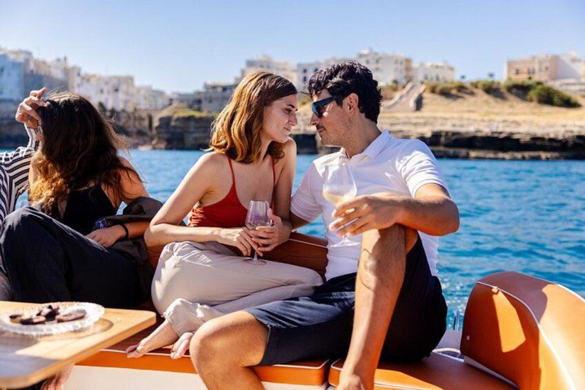 People on a boat with a coastal landscape in the background. 4