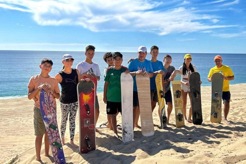 En gruppe mennesker på en strand med snowboard. 4
