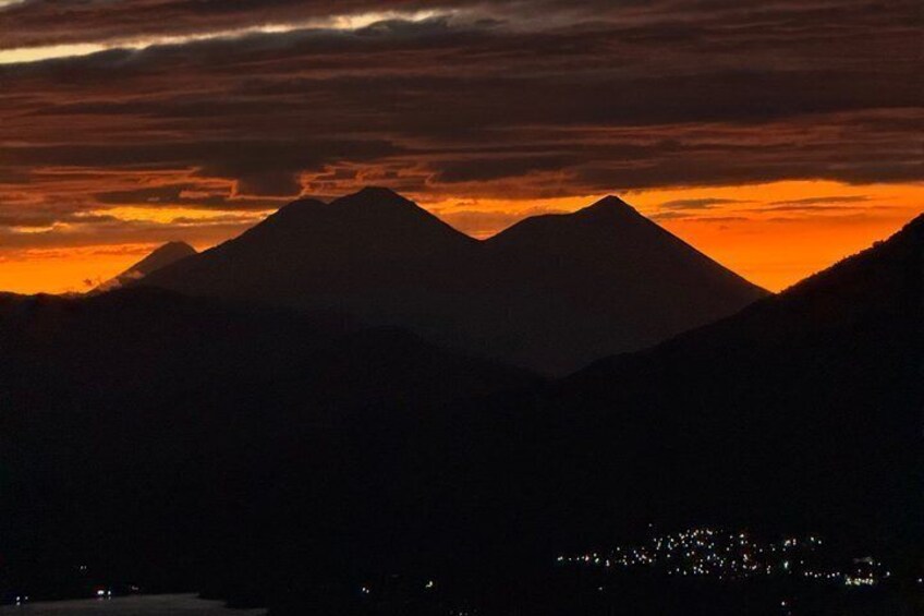 A mountain range silhouetted against a sunset sky. 3