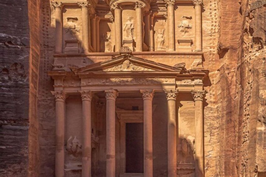 A grand ancient structure with columns and detailed carvings. 3