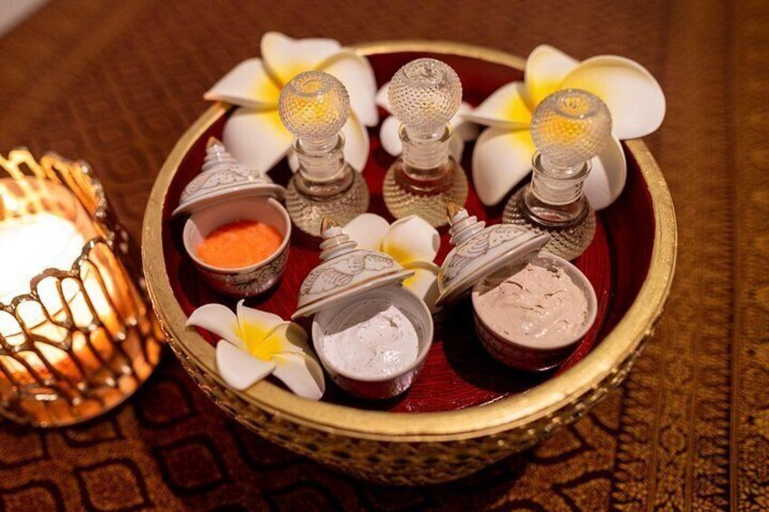 A decorative tray with salt lamps, flower petals, and small bowls of salt. 5