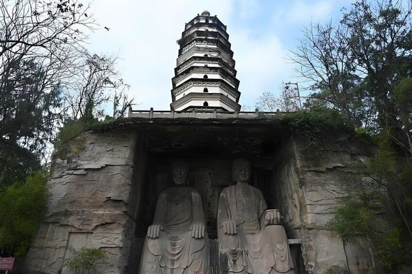 A pagoda with a Buddha statue in front. 4