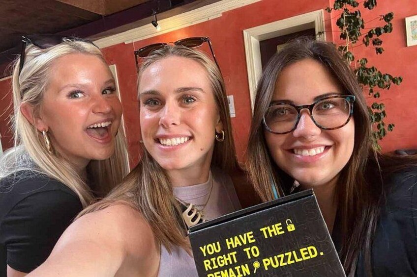 Three people holding a sign with text. 4