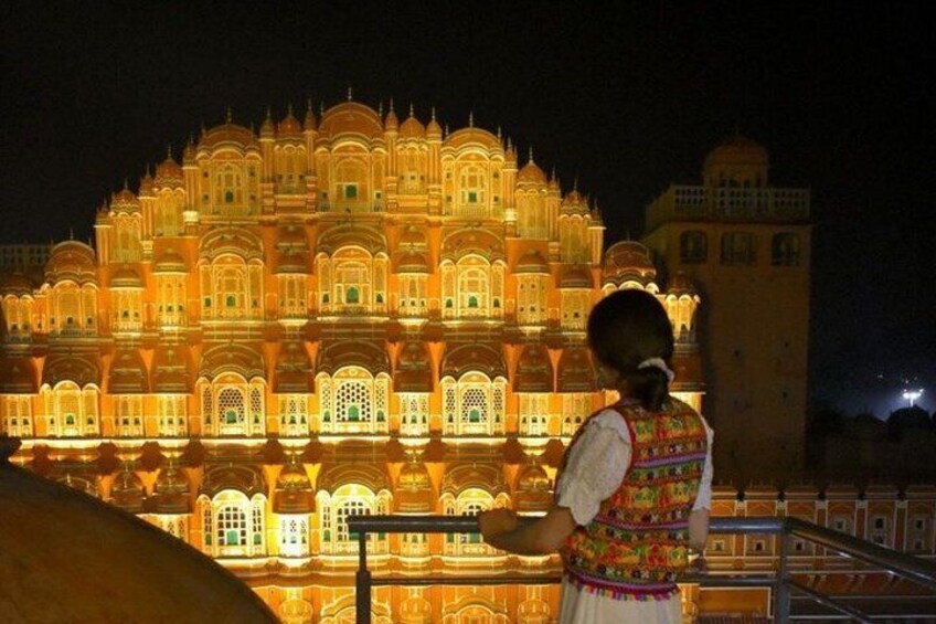 A brightly lit palace at night with intricate architecture. 5