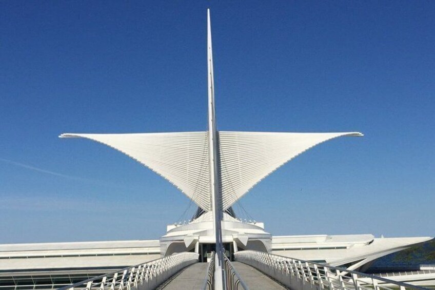 A modern bridge with a central tower and two large, triangular structures on either side. 3
