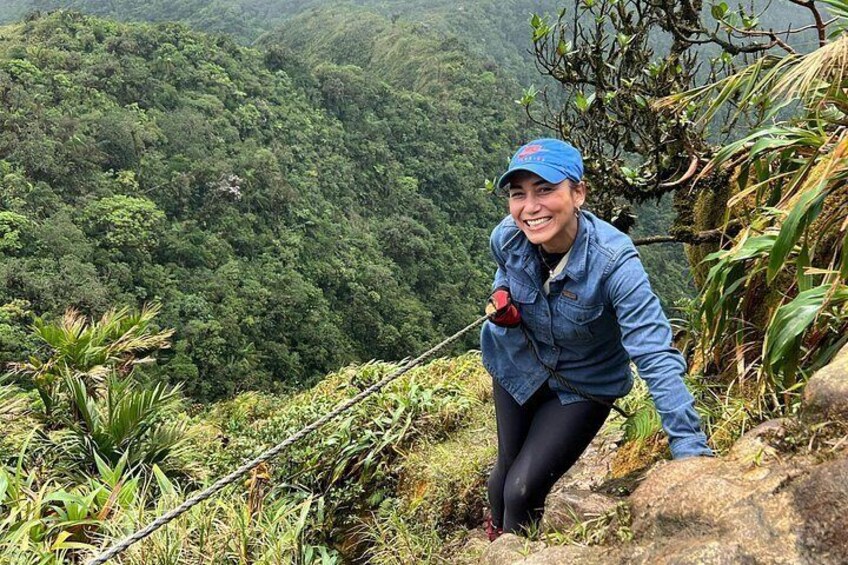 A person hiking on a rocky path surrounded by dense green forest. 2