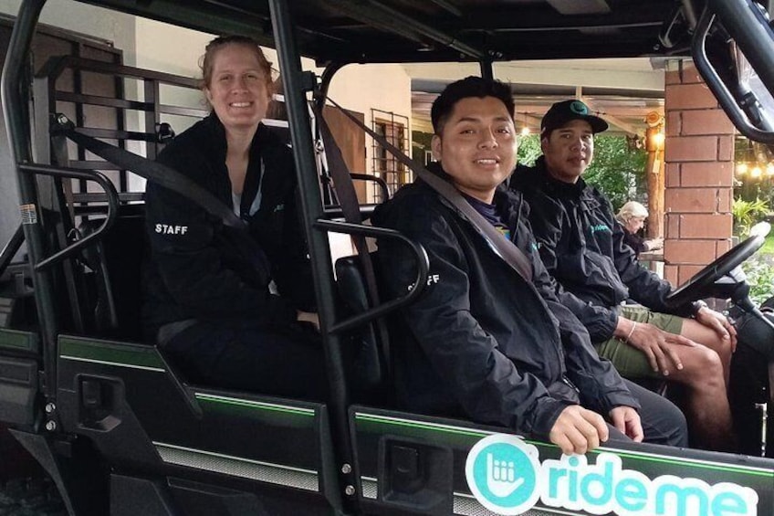 Three people in a golf cart with a 'ride me' sign. 4