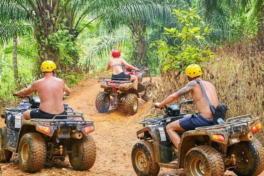 Three people on ATVs in a forested area. 5