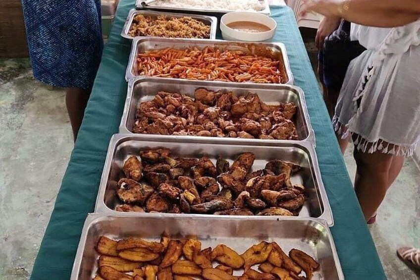 A buffet table with various food items in metal containers. 5