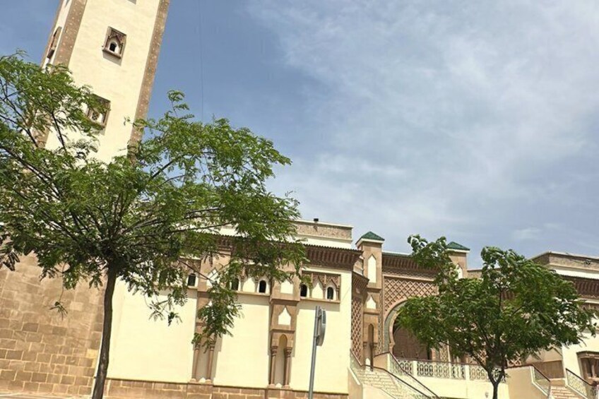 A historic building with a tower, arched windows, and a staircase. 3