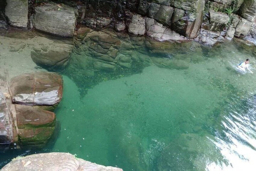 A clear water body surrounded by rocks. 5