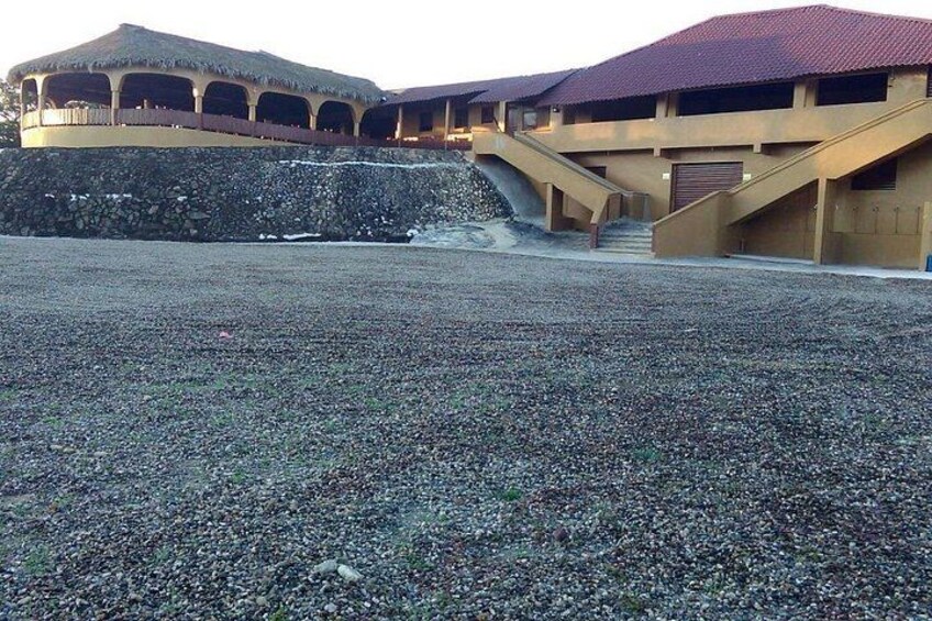 A building with a red roof and a stone wall. 3