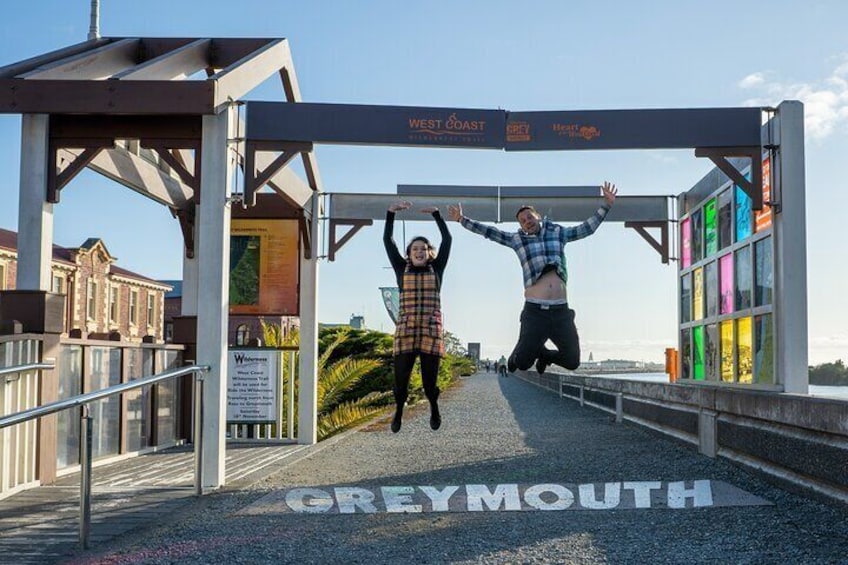 A pedestrian bridge with 'GREYMOUTH' written on the ground. 5