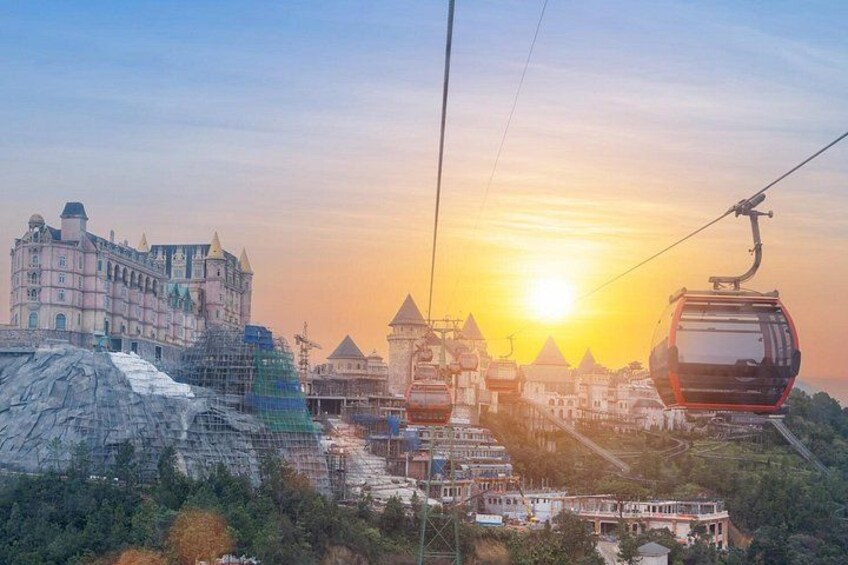A cable car system, a castle-like building, and a sunset. 5