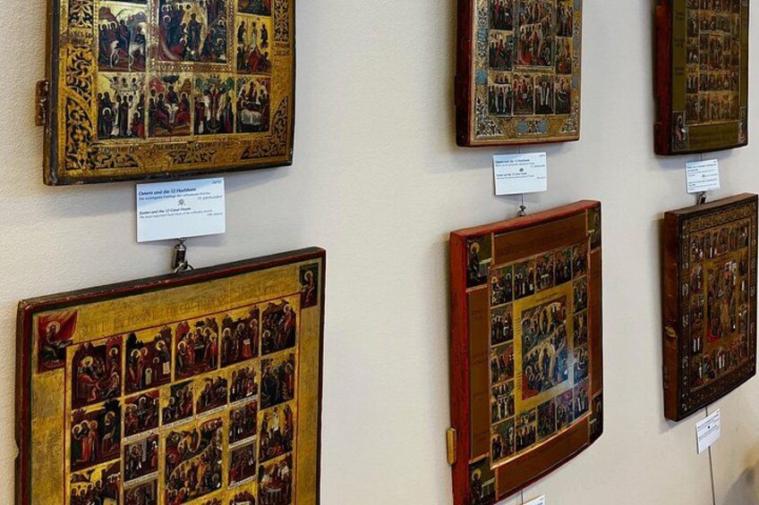 A collection of framed religious paintings on a wall. 4
