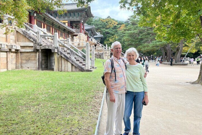 A traditional Korean building with a stone staircase and a paved walkway. 4