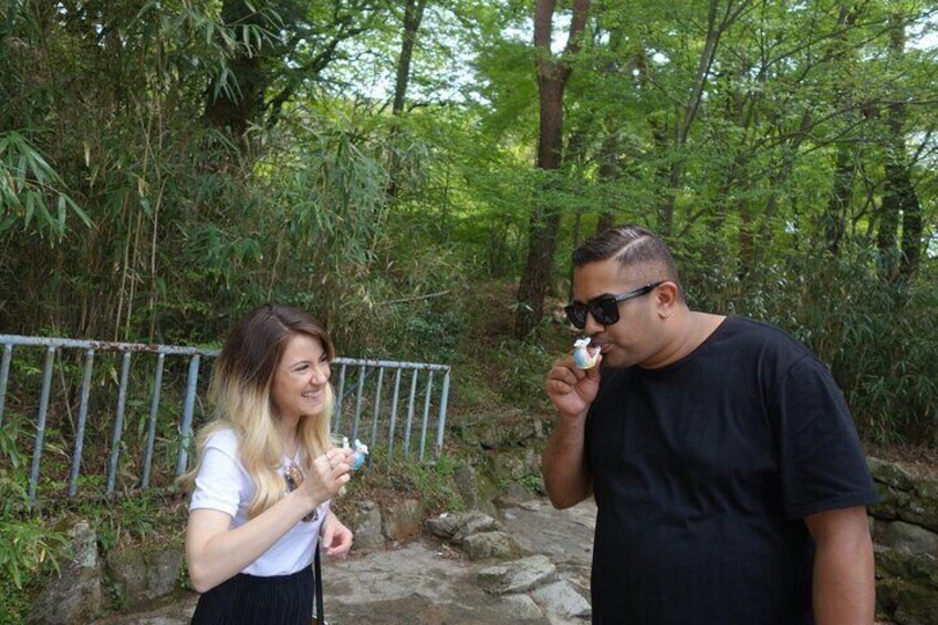 Two people standing on a stone path in a forested area. 3