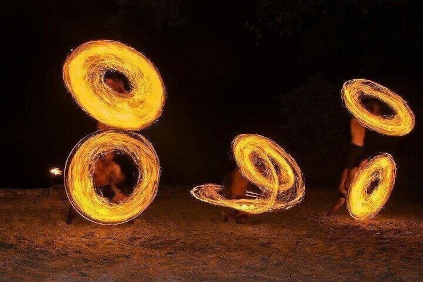 A person performing fire spinning with multiple fire rings. 3