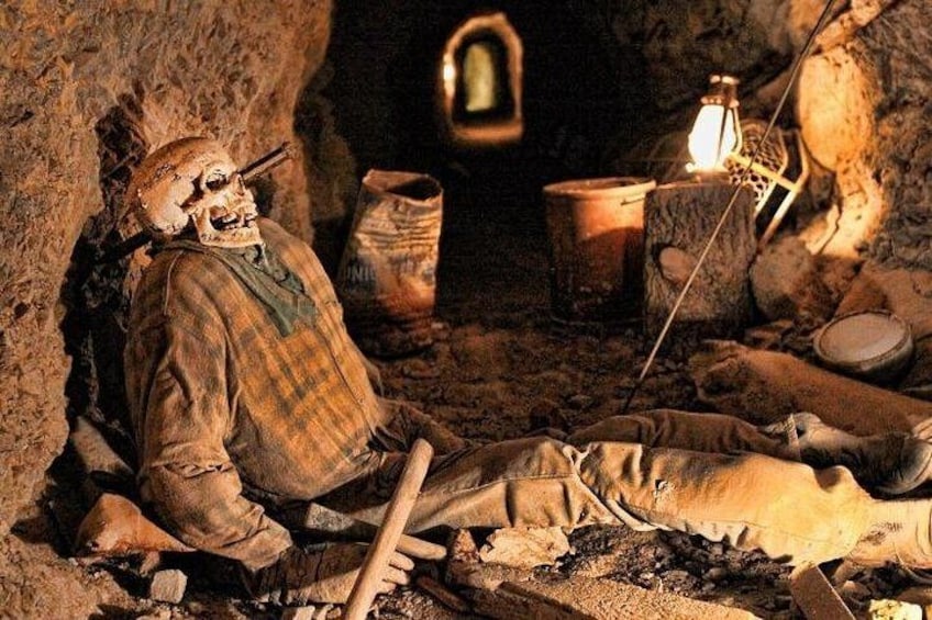 A mummy in a tomb with a lamp and pottery. 3