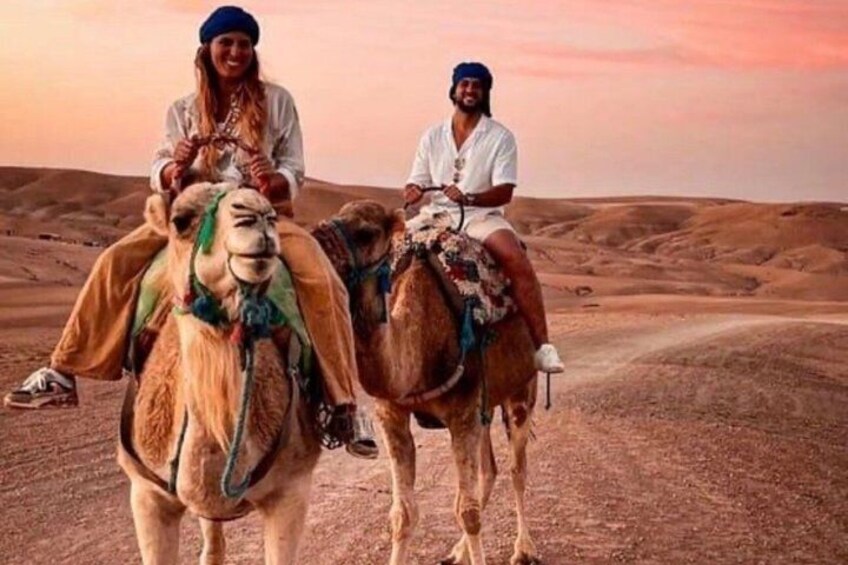 Two camels with riders in a desert landscape. 5