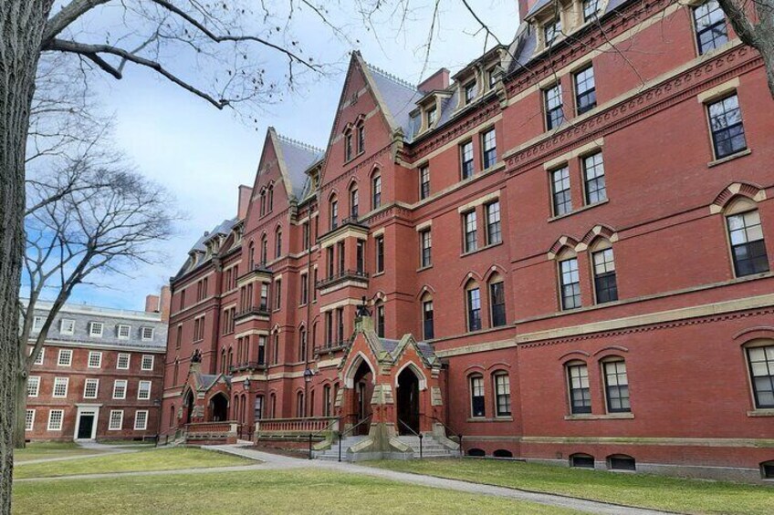 A large red brick building with a central entrance and multiple windows. 3