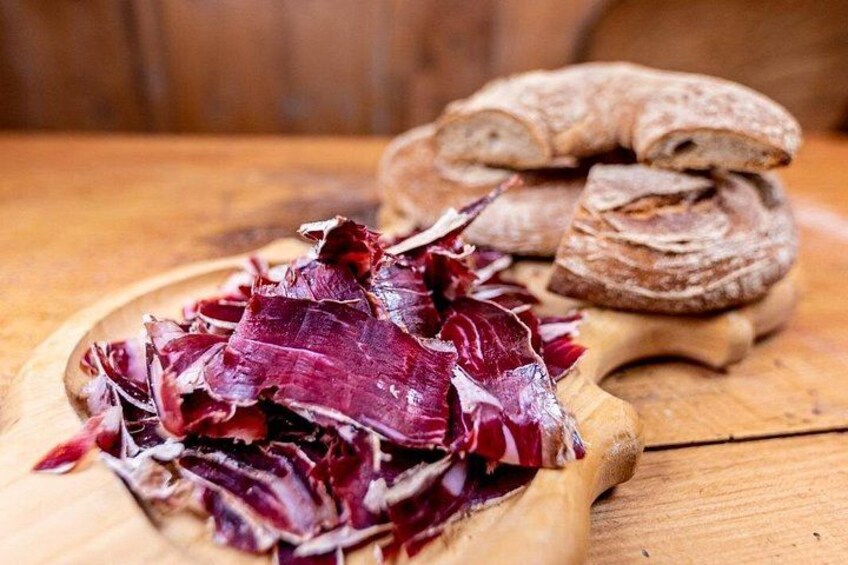 Sliced red cabbage on a wooden cutting board with a loaf of bread in the background. 4