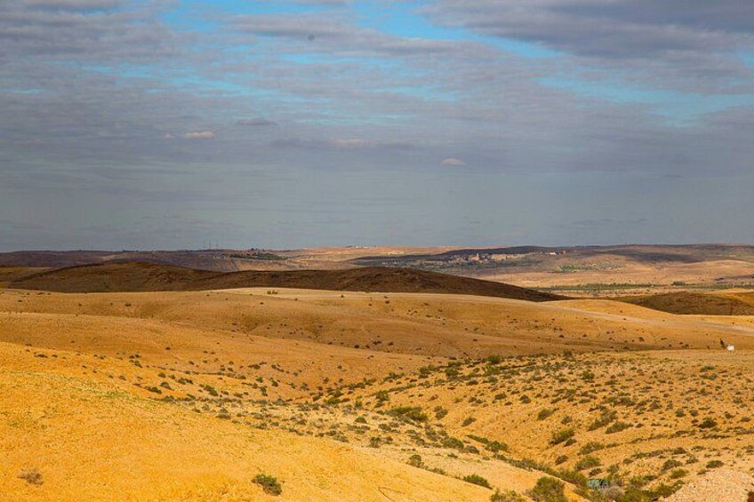 A desert landscape with rolling hills and sparse vegetation. 3