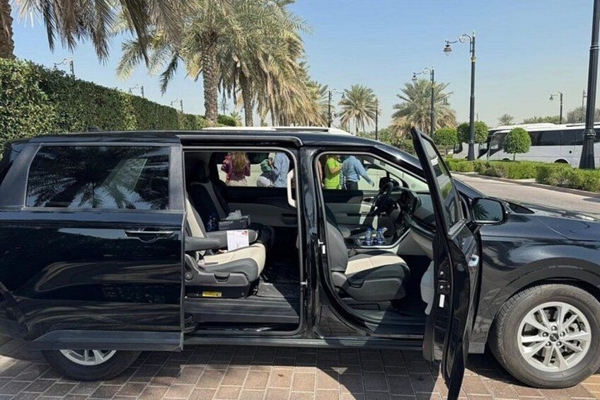 A black SUV with its door open, revealing the interior. 4