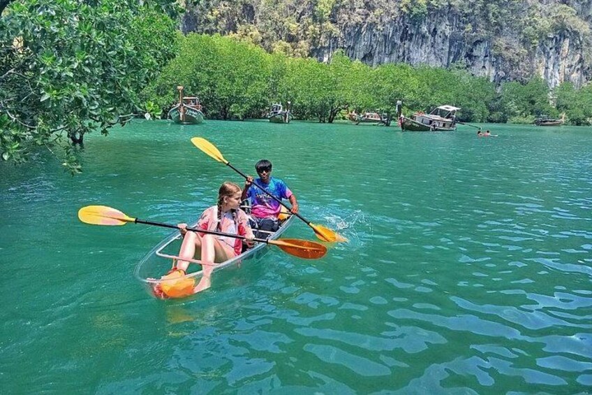 Due persone che fanno kayak su un fiume tranquillo, circondate da vegetazione rigogliosa e scogliere. 5