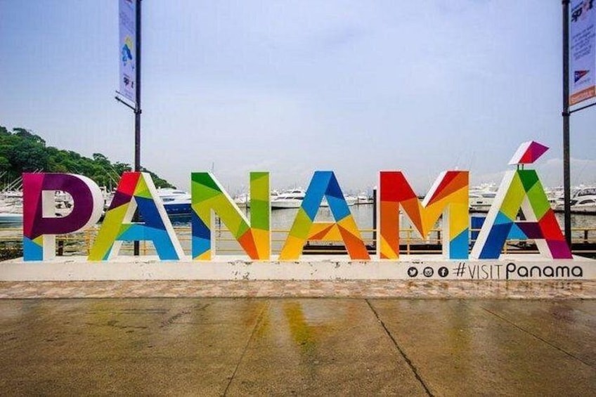 Colorful letters spelling 'PANAMA' with a hashtag '#VISITPanama' and a marina in the background. 3