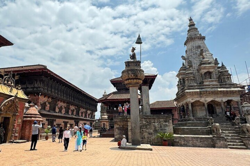 A temple complex with intricate architecture, including a large stupa and a multi-tiered structure. 5