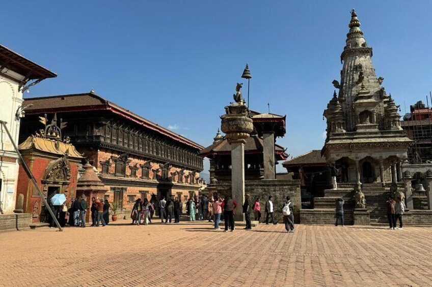 A historic building with intricate architecture, a large statue, and a traditional temple. 1