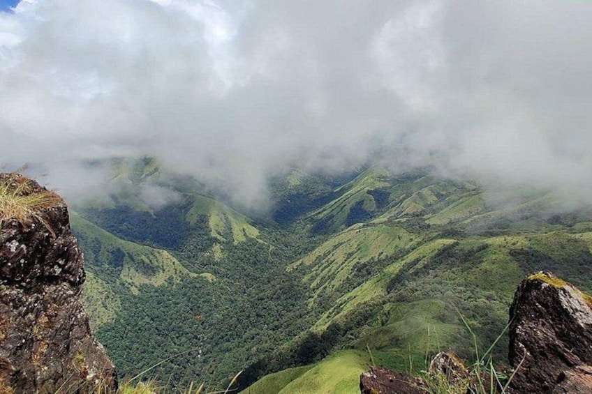 A mountainous landscape with lush green valleys and rocky outcrops. 4