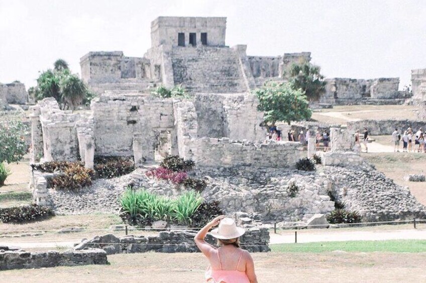 Ancient ruins with stone structures and a large tree in the foreground. 4