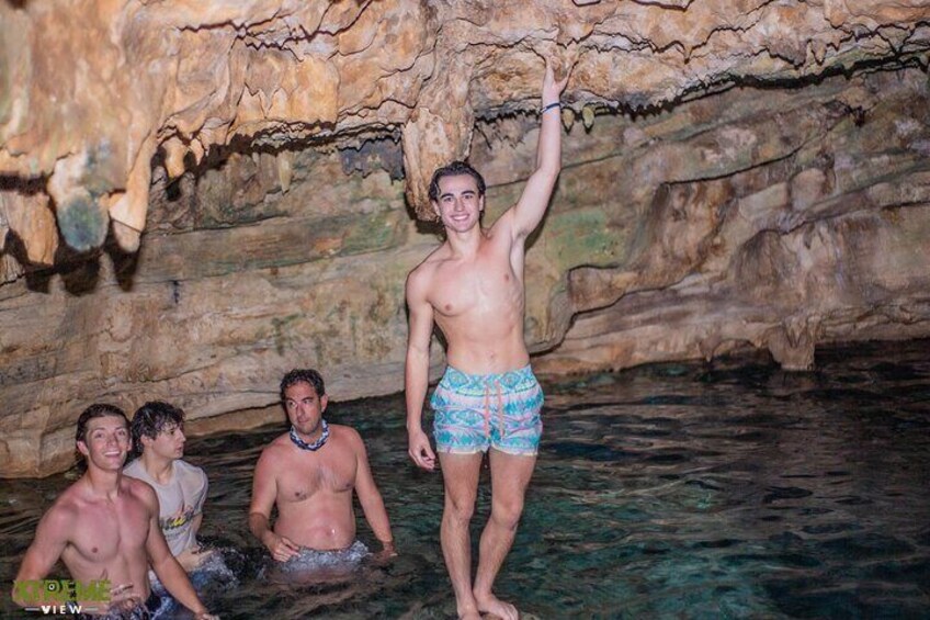 A group of people in a cave with water. 4