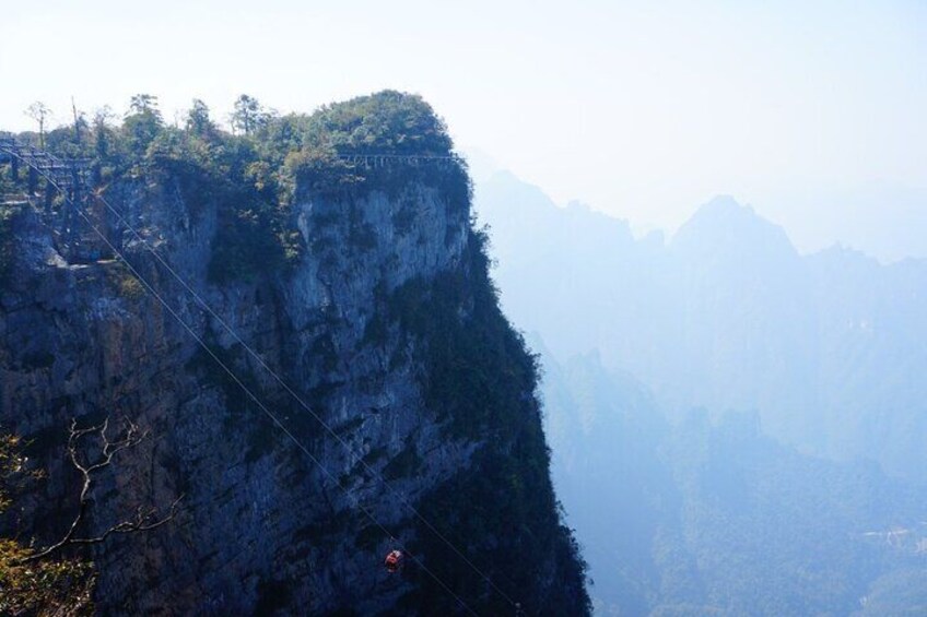 A steep mountain cliff with a suspension bridge. 3